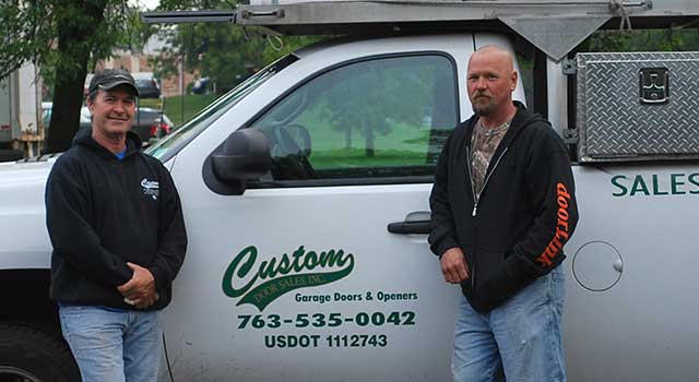 Custom Garage Door truck with two men in front