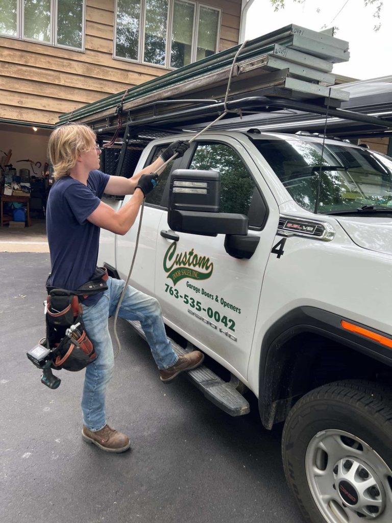 Employee attaching garage door parts to a truck