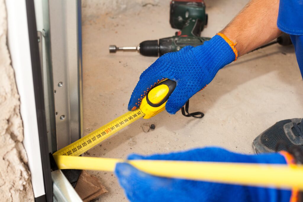 Man measuring garage door edge